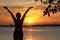 Silhouette woman raise hands feeling relax and freedom. People running and workout in sunset background.