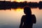 Silhouette of a woman in the river at sunset.