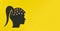 Silhouette of a woman's head with numbers in the brain. concept on a yellow background with copy space