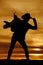 Silhouette of a woman with a saddle on her shoulder touch hat