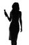 Silhouette of a woman singing with a microphone in hands