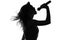 Silhouette of a woman singing with a microphone in hands