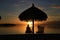 Silhouette of woman sitting on deck chair