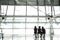 Silhouette of the woman sitting with friends by the windows of the airport with a view of the airfield with plane