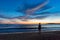 Silhouette Woman Standing At Beach During Sunset