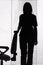 Silhouette of woman standing next to the chair (blind)