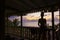 Silhouette of a woman standing on the porch watch  sunset over Caribbean  sea