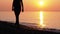 Silhouette of a Woman at Sunset Running along the Seashore