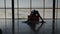 Silhouette of woman switching yoga positions at center next to the beach