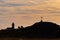 Silhouette of a woman on the top of a mountain at the foot of a cross