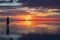 Silhouette of woman walking into the sunrise of lake Bonneville Salt Flats, Wendover, Western Utah, USA, America. Dreamy red