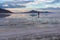 Silhouette of woman walking into the sunset of lake Bonneville Salt Flats, Wendover, Western Utah, USA, America. Beautiful summits