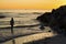 Silhouette of a woman walking through the surf near St. Pete Beach, Florida.