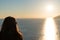 Silhouette of woman is watching sunset over the sea