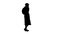 Silhouette Woman wearing medical mask walking and calling someone one the phone.