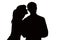 Silhouette of a woman whispers in the ear of beloved man
