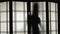 Silhouette of a woman who dances for translucent glass