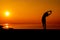 Silhouette woman workout alone with sunset background. Healthy and solo exercise activity. Wellness lifestyle