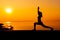 Silhouette woman workout alone with sunset background. Healthy and solo exercise activity. Wellness lifestyle