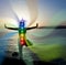 Silhouette of woman in yoga pose on beach sunset view, glowing s