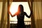 Silhouette of a women near the window on hotel