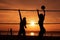 Silhouette women playing beach volleyball sunset