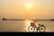 Silhouette women`s style bike at sunset on seascape with bridge and cloud sky. Vector illustration design