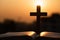 Silhouette of the wooden cross over opened bible with a bright sunrise as background , Christian, god