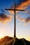 Silhouette wooden cross on the summit of a mountain.