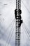 Silhouette of workers repairing communication tower