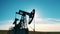 Silhouette of a working oil pumpjack in daylight