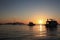 Silhouette yacht boat against the background of the sky of a sunny sunset. Silhouettes of ships on the background of the ocean and