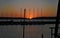 The silhouette of yacht masts against the setting sun