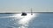 Silhouette of a yacht and sailboat in the Pacific Ocean in the afternoon sunlight