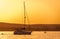 Silhouette of yacht at sunset moving on calm lake