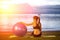 Silhouette yoga ball yung woman in the beach sunset