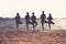 Silhouette of yoga group of people doing tree pose and namaste