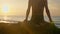 Silhouette yoga practice at sunset. Yong woman doing yoga exercise on the beach