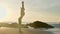 Silhouette yoga practice at sunset. Yong woman doing yoga exercise on the beach