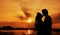 Silhouette of a young bride and groom on Sunset