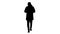 Silhouette Young casual man walking making a call wearing warm clothes and protective mask.