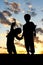 Silhouette of Young Children Holding Hands at Sunset