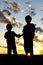 Silhouette Young Children Holding Hands at Sunset