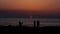 Silhouette of young couple enjoying beautiful sunset at the beach. Romantic moment human relationship