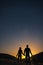 Silhouette of young couple holding hands under stars. The concept on the theme of love. romantic evening together, sunset,