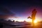 silhouette of young couple in love hugging on beach