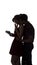 Silhouette of a young couple in love on white isolated background, man came up behind to woman to make a surprise with box present