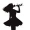 Silhouette of a young elegant woman in a dress and with a rose in hands, figure of romantic girl with a flower dancing from