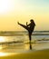 Silhouette of young fit Muslim woman covered in Islam hijab head scarf training martial arts karate kick attack and fitness