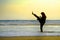 Silhouette of young fit Muslim woman covered in Islam hijab head scarf training martial arts karate kick attack and fitness